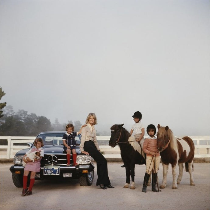 Anne Anka by Slim Aarons - A photographic print of Anne Anka posing with her four children and two horses.
