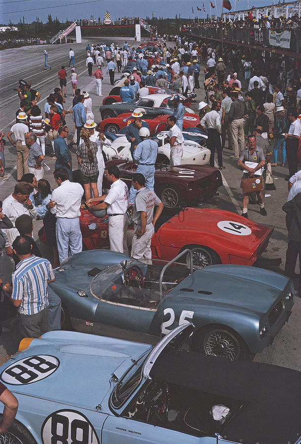 Bahamas Speed Week II by Slim Aarons - A vintage photographic print of race teams gathering at a car racing event in the Bahamas.