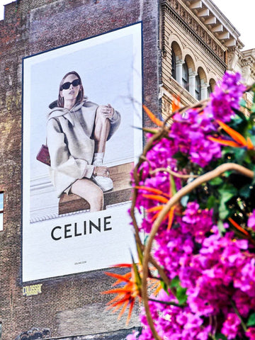 Celine Blooms by Giclée Studios - New York street photography capturing a beautiful old building with Celine advertisement and bold flowers.