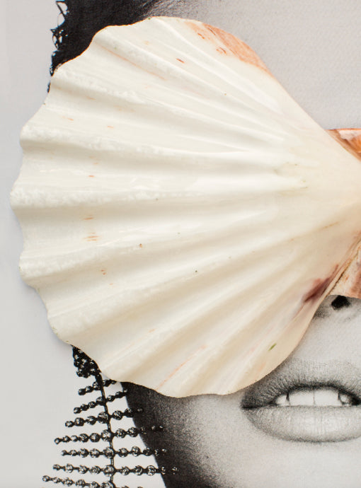 Sweet Nothings by Dina Broadhurst - A black and white photograph of a face, shot close up, with a cream sea shell placed on top. A statement, glittering earring peeks through the shell to bring a bit of sparkle to the coastal-feeling image.