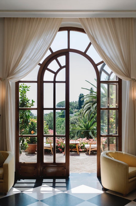 Belmond Hotel Splendido by Via Tolila - A photographic print captured at the luxury hotel, Belmond Hotel Splendido, overlooking the exquisite views of Portofino through an arched doorway.