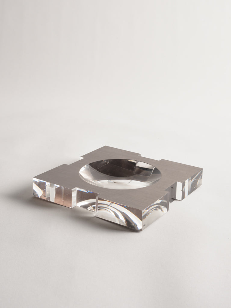 Carter Acrylic Bowl Brushed Platinum Large by Greg Natale - Clear glass candle holder with metallic base on a light grey background