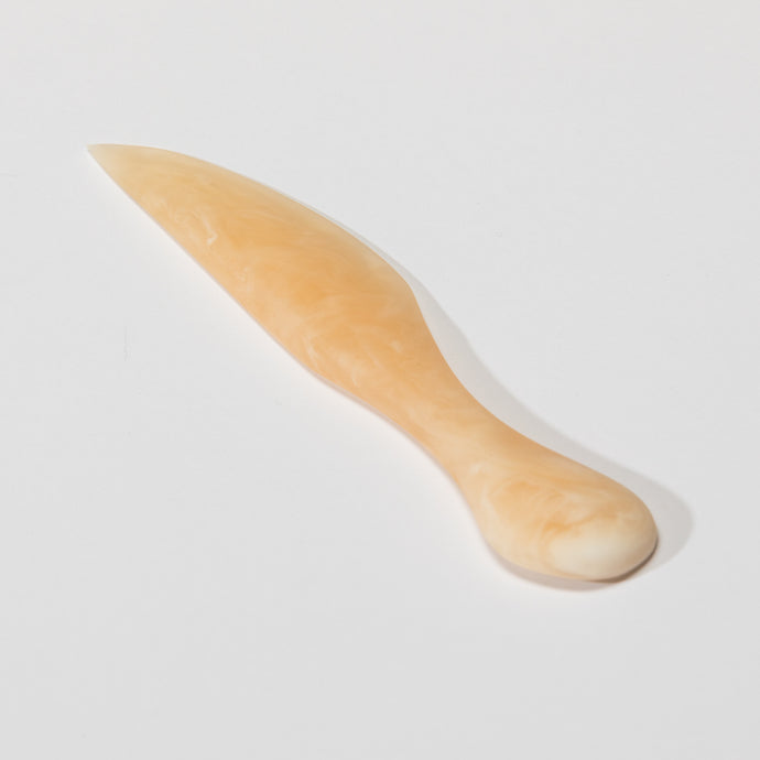 Cheese Knife Coral by Keep Store - An image of a resin cheese knife in coral.