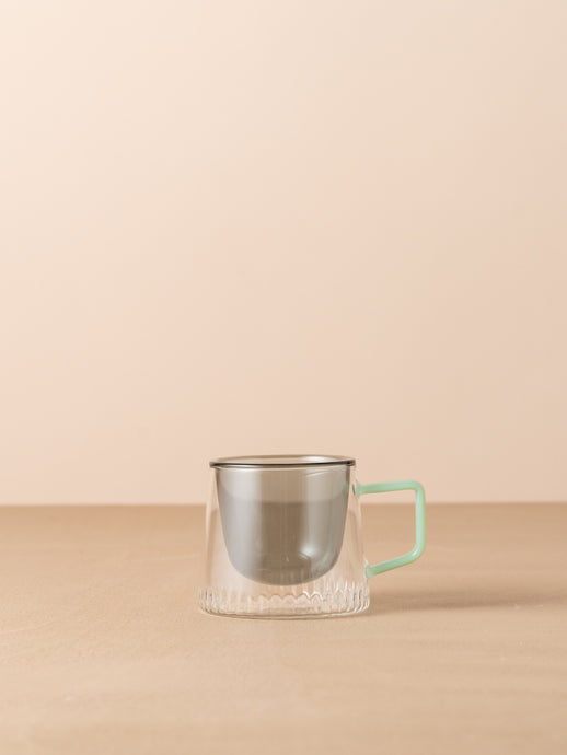 Kairos Coffee Cup Smoke by Saardé - A glass coffee cup with a mint handle and a smoke coloured well.