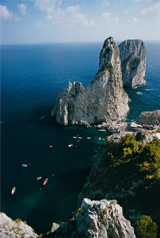 Faraglioni Rocks by Slim Aarons - Aerial photo of rocks and the sea