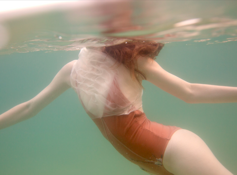 Feminine by Francesca Owen - Film photograph of swimmer in red leotard underwater.