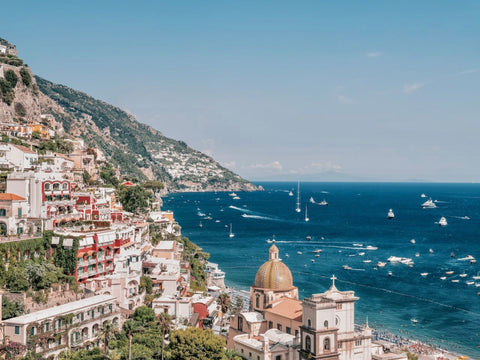 From Positano with Love by Stuart Cantor - A photographic print of coastal buildings in delicate red and cream hues with views across the Amalfi Coast.