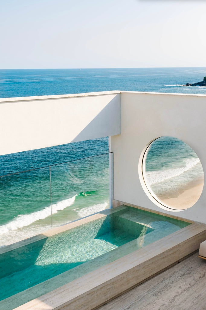 Granite Pool Over the Atlantic by Via Tolila - A photographic print of ocean views in soft blue tones.