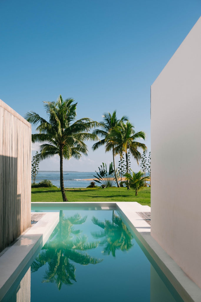 Hidden Gem of Bahia by Via Tolila - An exquisite photographic print of a pool with palm-tree lined ocean views in Bahia, Brazil. 