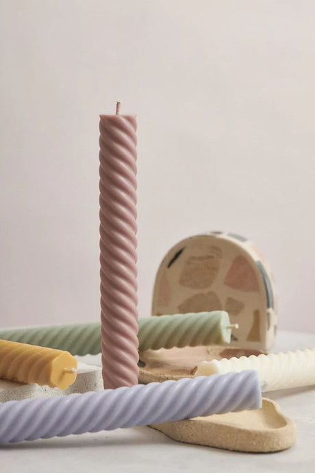 Lola Swirl Dinner Candle Pair - Mallow by Flört Designs - An image of a mallow coloured candle stick with a swirled rib texture, shown in a table setting.
