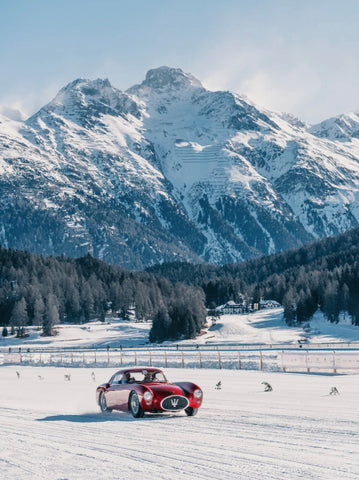 Maserati Magnifique by Stuart Cantor - A photographic print of a vintage Maserati car driving on a snowy road.