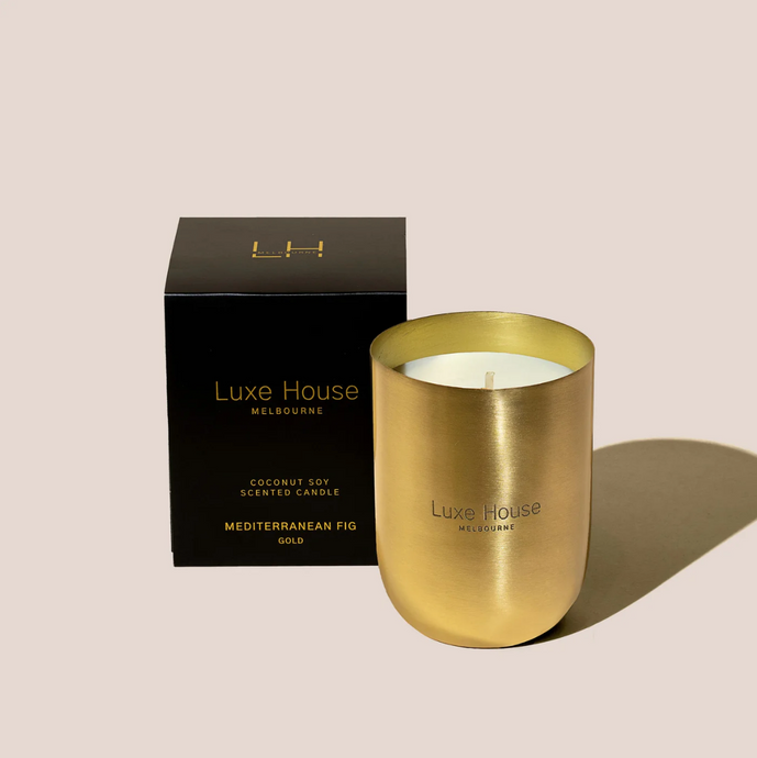 Mediterranean Fig Gold by Luxe House - Fig scnted candle in a brass vessel with black packaging.