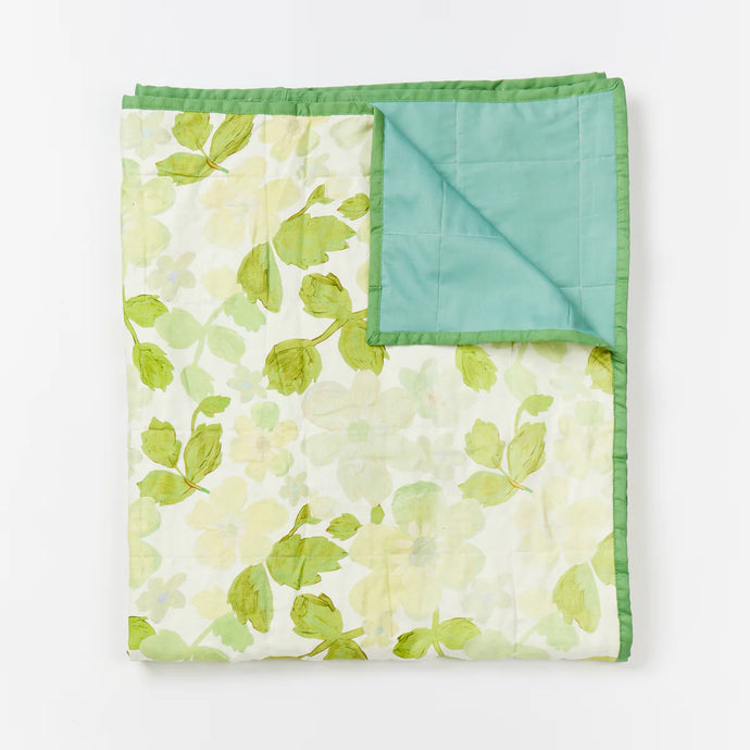 Mini Pastel Floral Green Quilted Throw by Bonnie and Neil - An image of a green floral print quilt, with a solid green trim and reverse side.