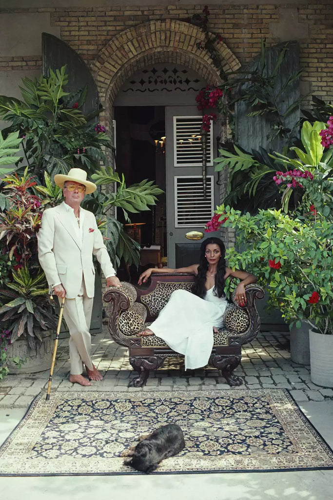 Olivier Coquelin by Slim Aarons - Photo of Olivier Coquelin and Lahaina Kameha on leopard print chair with foliage.