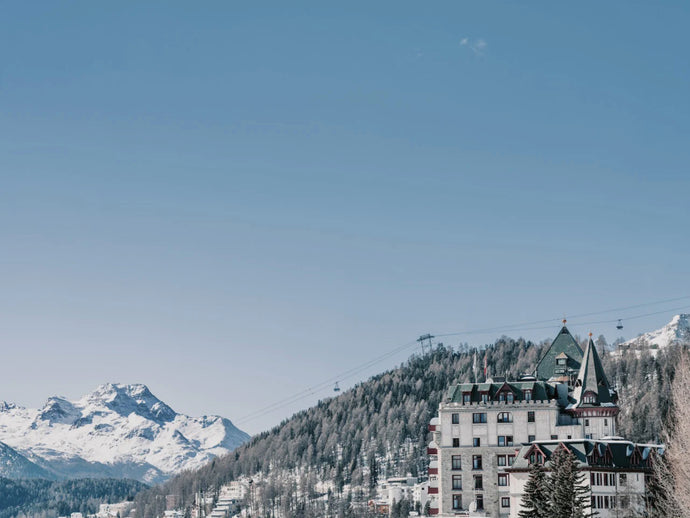 Palace Sky by Stuart Cantor - A photographic print capturing the iconic palace in St Moritz, Switzerland, surrounded by snow-topped mountains.