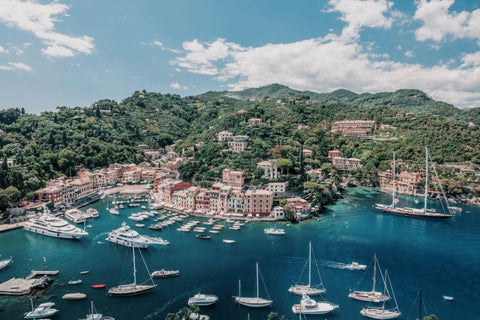 Portofino Harbour by Stuart Cantor - A photographic print of a mediterranean ocean view in blue, green and red pastel hues across Portofino, Italy.