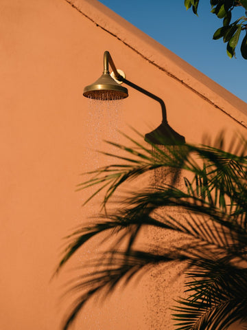 Riad Pompon Marrakech by Via Tolila - A photograph captured at this boutique hotel a vibrant quintessential Moroccan backdrop of rust coloured buildings and greenery.
