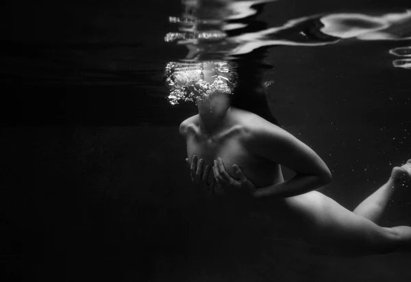 Signature Series #2 by Francesca Owen - A photographic print of a woman swimming, viewed from underwater.