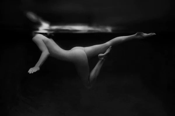 Signature Series #5 by Francesca Owen - A photographic art print of a woman swimming, viewed from underwater.