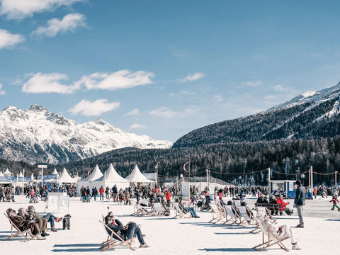 Sun Lounging in St Moritz by Stuart Cantor - A photography print capturing loungers on deck chairs in the snow.