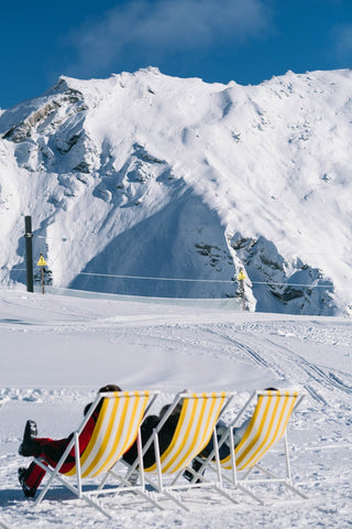 Val D'isere II by Via Tolila - A photographic print of yellow sun loungers in the snowy mountains of Val D'isere in France.