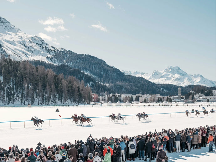 White Turf by Stuart Cantor - A photographic print capturing horses racing on a snow-lined road set amongst the mountains of St Moritz.