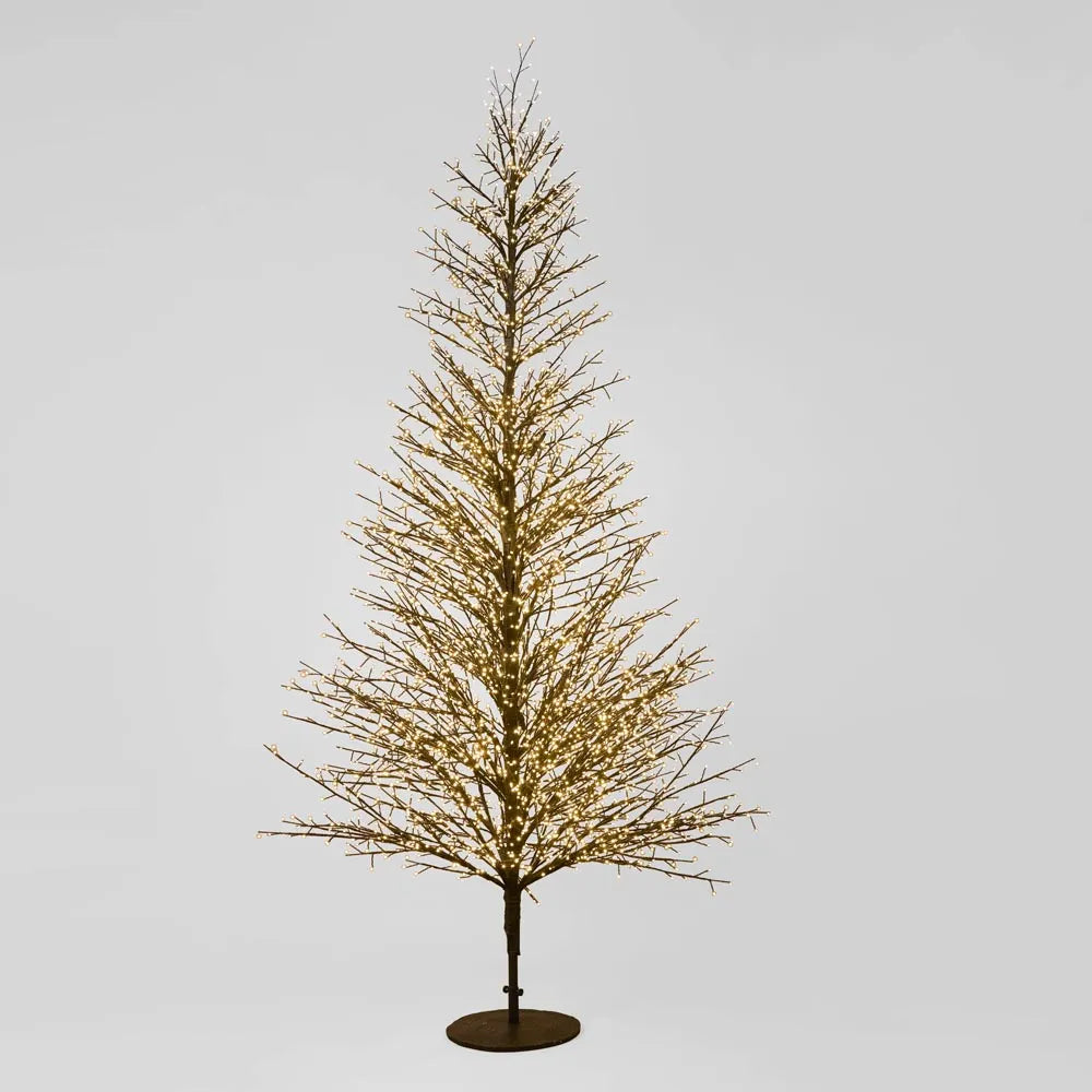 Giant Black Forest Christmas Tree - Decorative tree with lights on a gray background