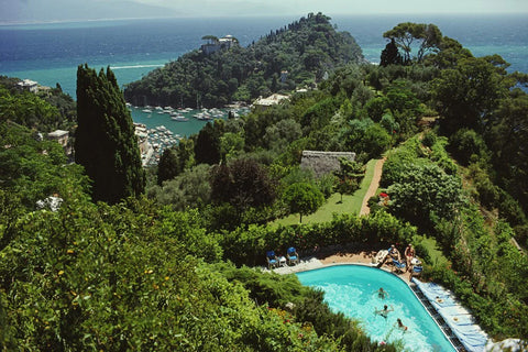 Portofino Villa by Slim Aarons - Photo of view over villa and Portofino harbour Italy with trees and pool.