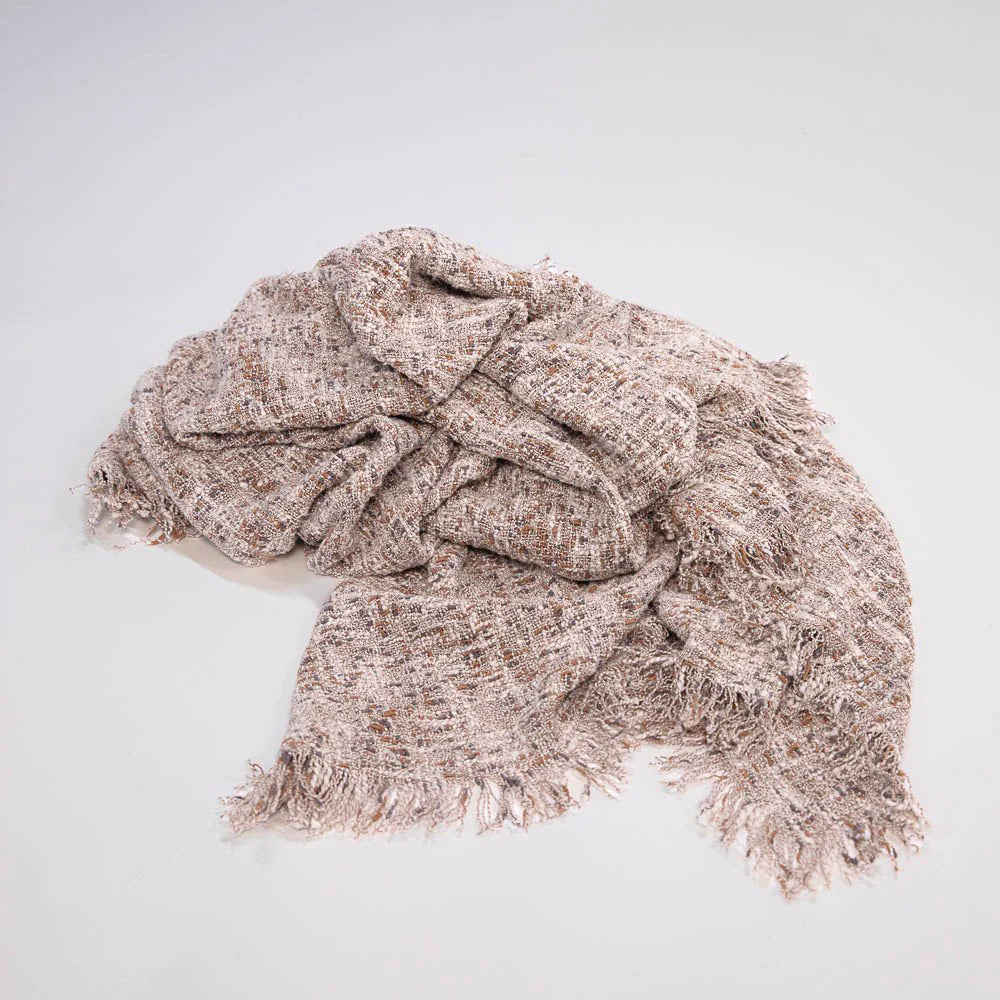 Ritchi Throw by Eadie Lifestyle - Woven beige throw with fringes on a light gray background