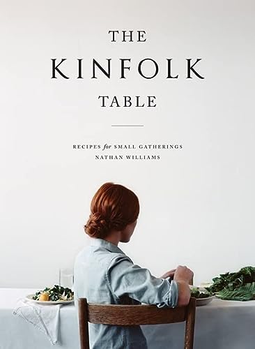 The Kinfolk Table by Nathan Williams - Book cover with text about recipes for small gatherings and image of woman from behind sitting at dining table.