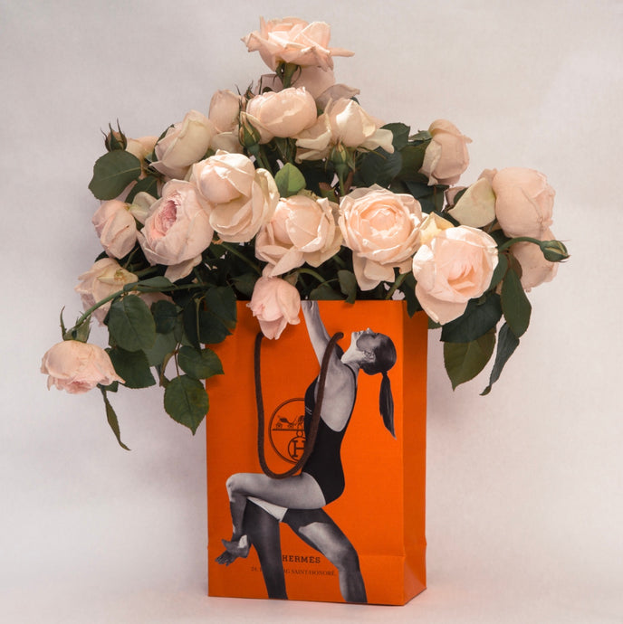 Bagged It (Hermes/Swing) by Dina Broadhurst - An orange Hermes bag is filled with pink garden roses
