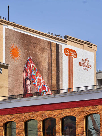 Casa Hermes by Giclée Studios - A photographic print of a building with hand painted Hermes Paris advertisement on red brick building