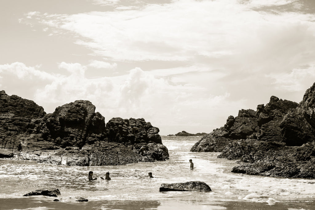 Childhood at Seal Rocks by Kara Rosenlund - A coastal photograph of the ocean shoreline with rock formations in the shallows.