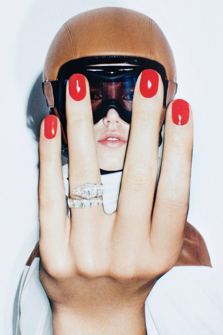 Easy Rider by Dina Broadhurst | FRAMING TO A T - A photo of a lady wearing a chic riding Helmut and goggles, with glossy red nails and diamond ring.