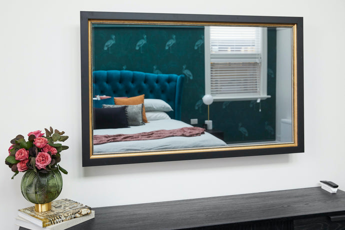 TV-Mirror with Black Square Frame and Gold Edging by FRAMING TO A T - TV Mirror with black and gold frame in bedroom