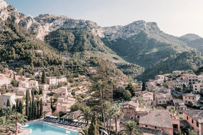 La Residencia by Stuart Cantor - A photographic print of Spanish buildings and mountains, with greenery throughout.