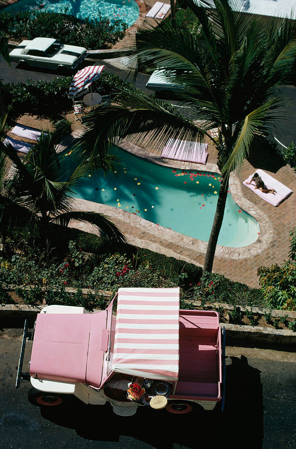 Las Brisas II by Slim Aarons - A striped pink car parked above a large villa pool.