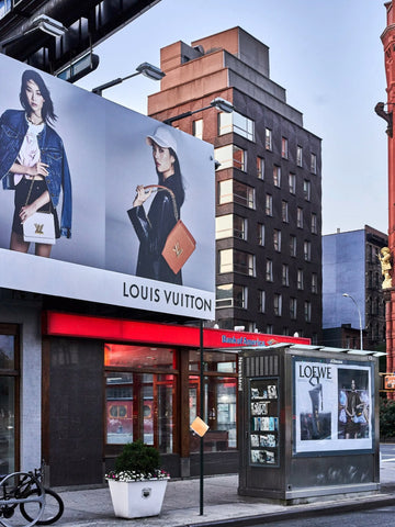 Loewe Vuitton by Giclée Studios - A photographic print of a streetscape with Louis Vuitton & Loewe advertisements