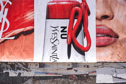 NU YSL by Giclée Studios - A streetscape photographic print in bright reds featuring advertisements for YSL beauty.