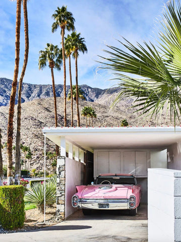 Pink Cadillac by Giclée Studios - A photograph of a vintage pink Cadillac park in the carport of a Mid Century Modern home, with the amazing backdrop of the Palm Springs landscape.