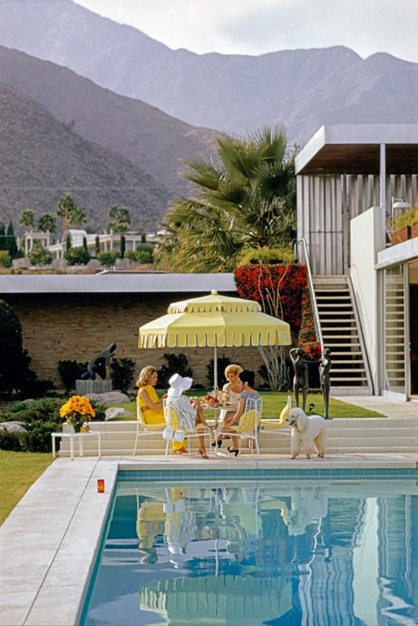 Poolside Friendship by Slim Aarons - Ladies lounge for lunch at the mid century modern desert house in Palm Springs, 1970