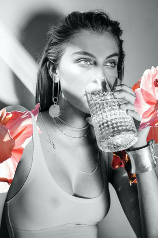 Pure by Dina Broadhurst - Collage artwork black and white photograph of girl drinking from a glass with pink flowers collaged on her shoulders