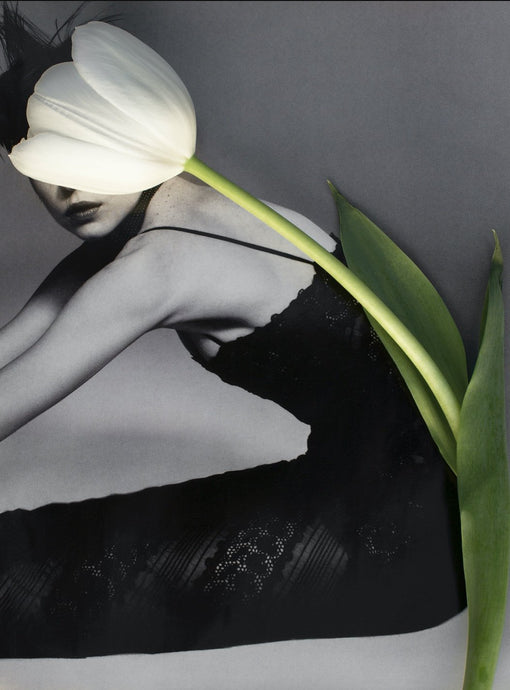 Round & Round by Dina Broadhurst - Collage artworkl black and white photograph of a girl sitting, facing sideways, reaching to touch her toes out of shot with a white tulip