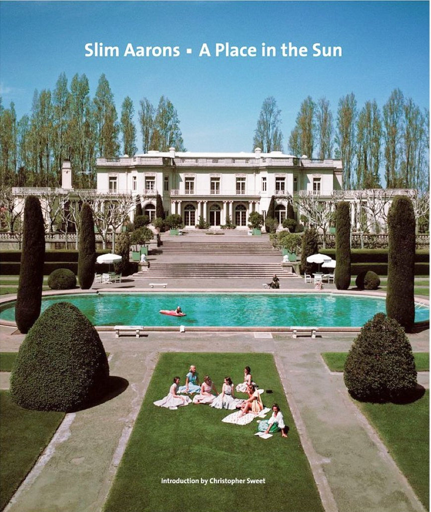 Slim Aarons, A Place in the Sun by Slim Aarons - Grand house estate with steps leading into a pool and a group of people sitting on the lawn