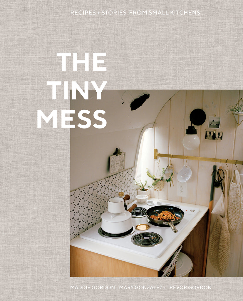 The Tiny Mess by Trevor Gordon - Woven grey background with an image of a tiny kitchen, a tiny electric stove and frypan cooking