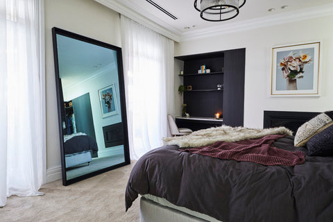 Leaner TV-Mirror with Black Frame by FRAMING TO A T - TV Mirror with black frame leaning against a bedroom wall