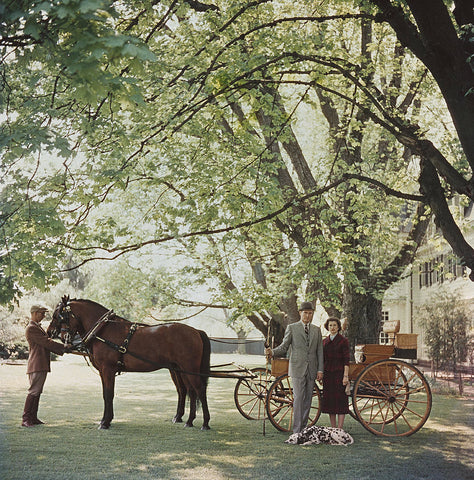 We Know Our Place - A married couple standing beside a pony and its instructor in their garden, with a Dalmatian at their feet.