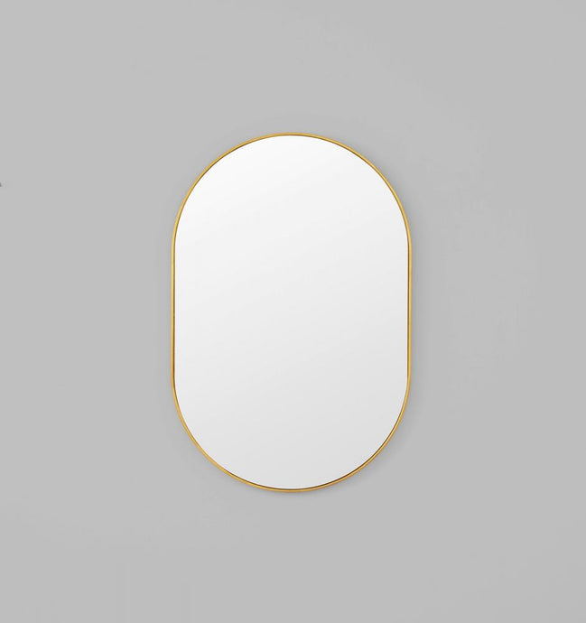 Bjorn Oval Brass Mirror by Middle of Nowhere. Streamline minimal design oval mirror with brass gold leaf engineered wood frame to enhance any space.